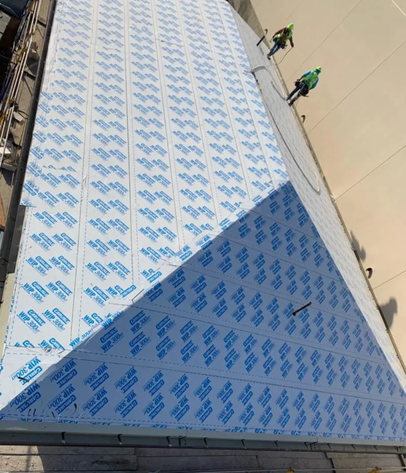 Professional roofers installing underlayment on a metal roof in Parma Heights